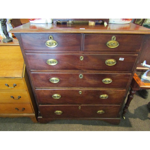 1124 - A late Georgian mahogany split chest of two short over four graduating long drawers with oval brass ... 