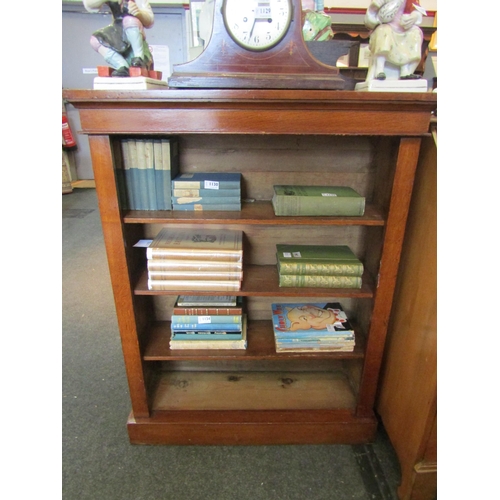 1135 - An oak four tier bookcase, 107cm tall x 83cm wide x 27cm deep