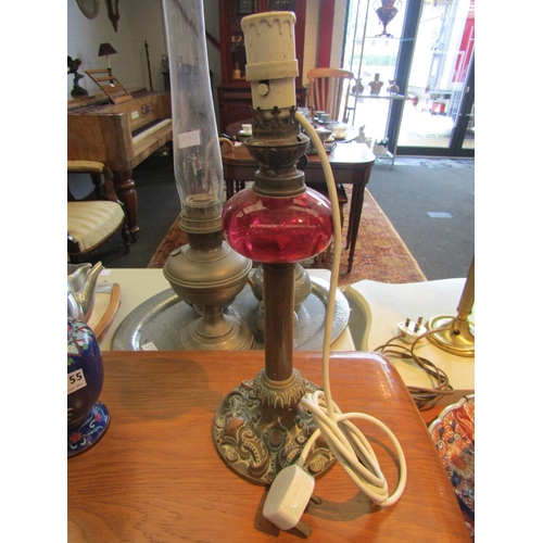 1154 - A pair of 19th Century brass oil lamp bases, foliate relief detail