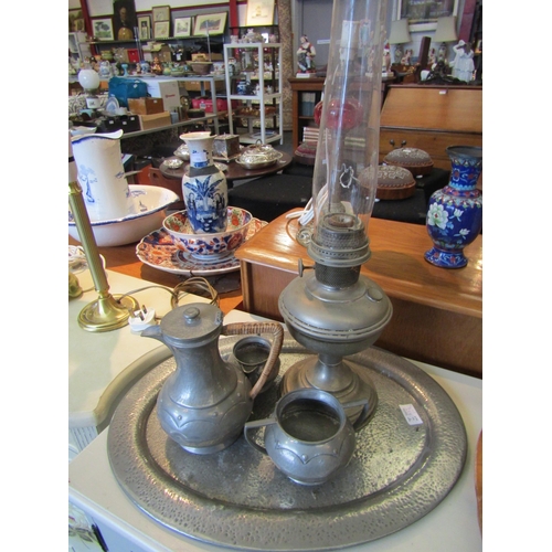 1167 - An oval pewter tray, coffee pot, sugar bowl, jug and Aladdin Industries oil lamp (5)