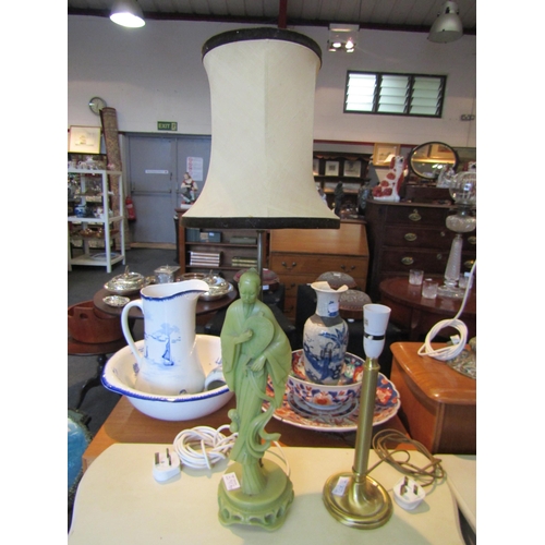 1169 - A brass effect table lamp and a resin table lamp depicting an Oriental figure (2)