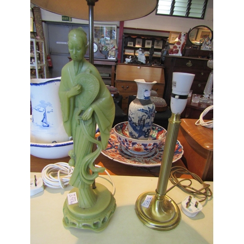 1169 - A brass effect table lamp and a resin table lamp depicting an Oriental figure (2)