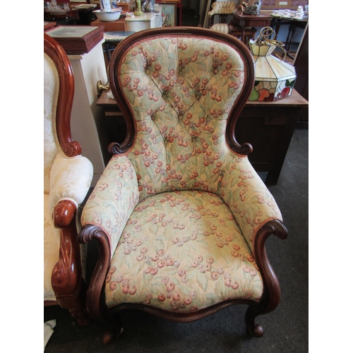 1193 - A Victorian spoon button back armchair with fruiting leaf upholstery on cabriole fore legs to cerami... 