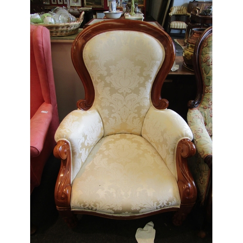 1194 - A modern spoon back armchair with cream foliate upholstery, melon fluted fore legs