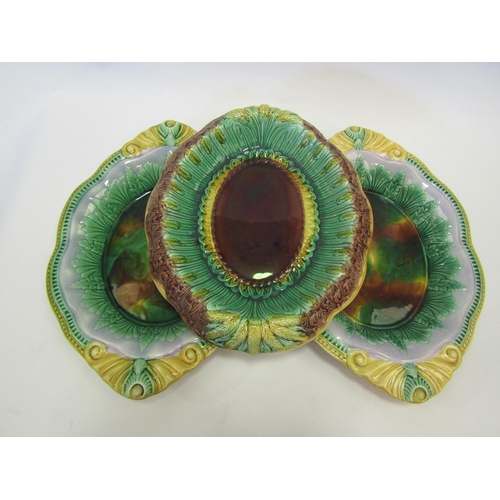 1329 - A pair of Victorian majolica glazed dishes with a similar oval bread plate moulded with basket weave... 