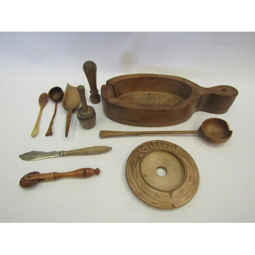 1332 - A collection of treen kitchen tools including 19th Century butter mould, pastry wheel cutter, scoop,... 