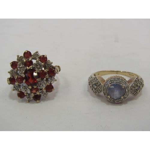 1366 - Two 9ct rings, one pale blue/purple stone in centre and other with red stones