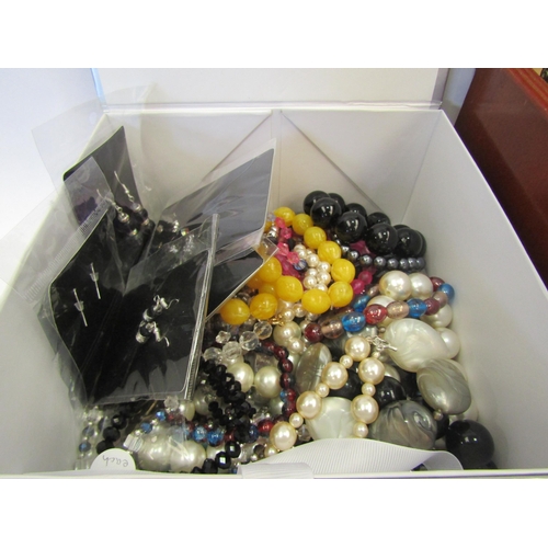 1379 - Two boxes containing a quantity of costume jewellery including bead necklaces, rings, etc,