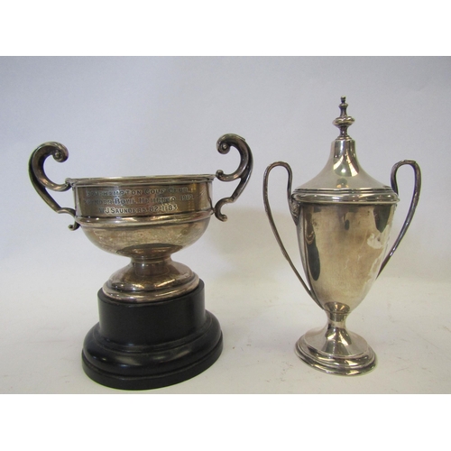 1403 - A silver twin handled cup with cover and a silver trophy cup on stand