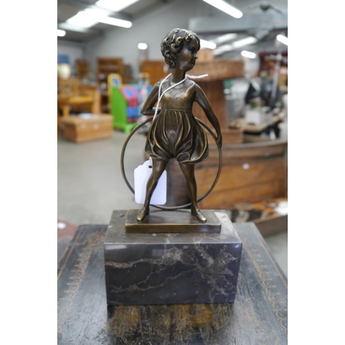 2003 - An Art Deco form bronze figure of girl with hoop