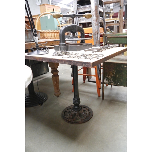 2035 - A oak topped, cast iron base table