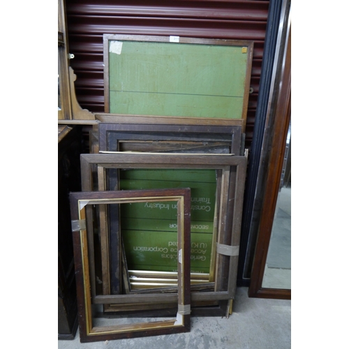 2111 - A mahogany display notice board and a bundle of oak picture frames