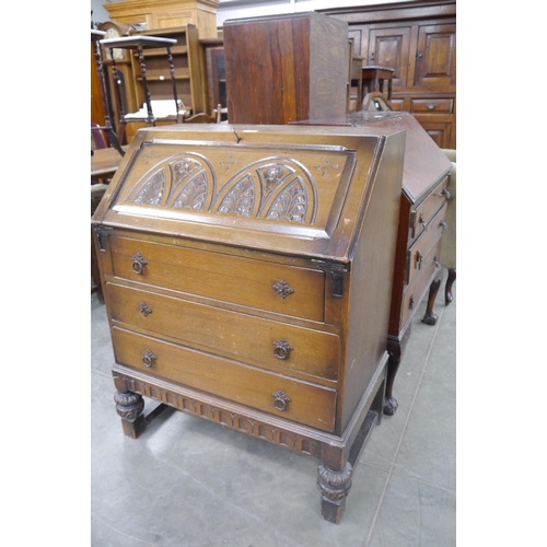 2483 - A carved oak bureau