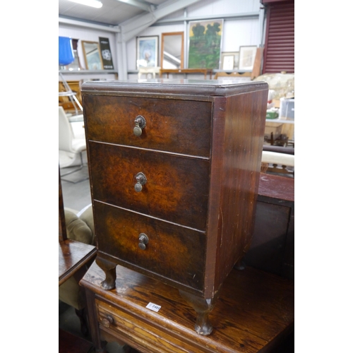 2484 - A walnut three drawer pot cupboard