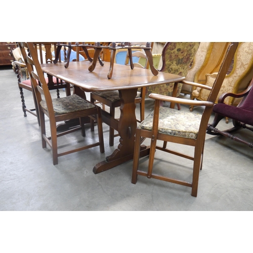 2488 - An Ercol rectangular dining table with four matching Ercol ladder back dining chairs (2+2)