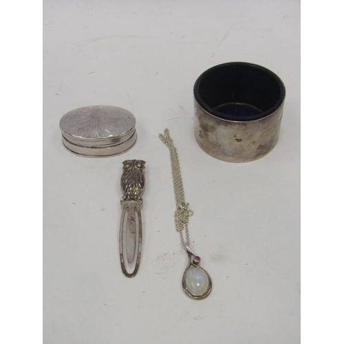 1354 - A group of silver items including a pill box, owl page marker, silver table salt with blue glass lin... 