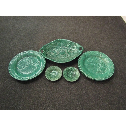 1463 - A set of four Victorian green glazed dessert plates moulded with vine leaves. A similar two handled ... 