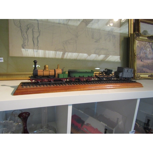 1485 - Two cased displays of steam locomotives with tenders and another train on track (lacking case)  (3)