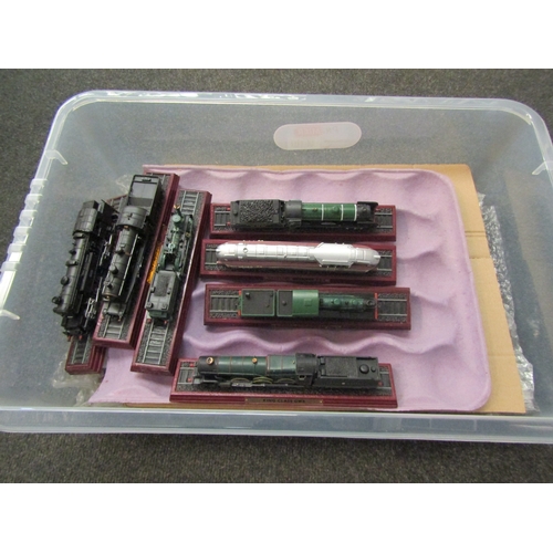 1552 - A box containing a quantity of model train engines, approximately 20