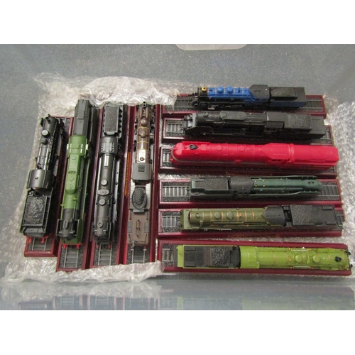 1552 - A box containing a quantity of model train engines, approximately 20