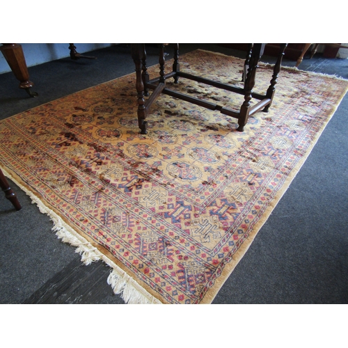 1619 - A mustard ground wool rug, geometric design, multiple borders, tasselled ends, 270cm x 180cm