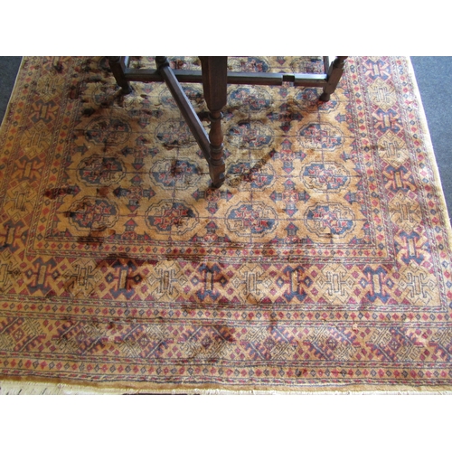 1619 - A mustard ground wool rug, geometric design, multiple borders, tasselled ends, 270cm x 180cm