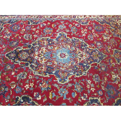 1198 - A Turkish wool red ground rug, multiple borders, 200cm x 310cm