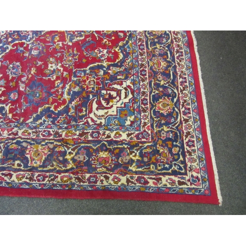 1198 - A Turkish wool red ground rug, multiple borders, 200cm x 310cm