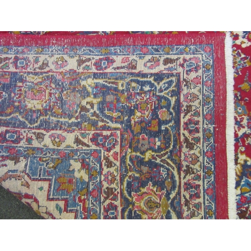 1198 - A Turkish wool red ground rug, multiple borders, 200cm x 310cm