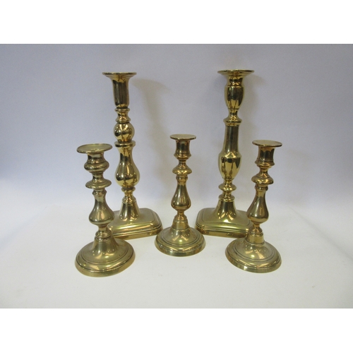 1243 - A pair of 19th century brass ejector candlesticks. 20cm tall. A similar candlestick. A couple of 19t... 