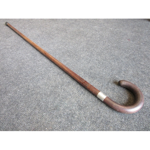 1250 - A walking stick with silver band, marked Harrod's, London