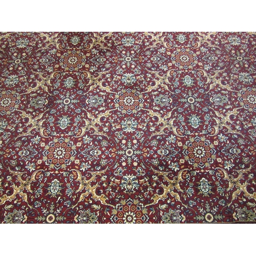 1622 - A modern red and gold ground carpet with floral decoration, multiple borders, 345cm x 250cm