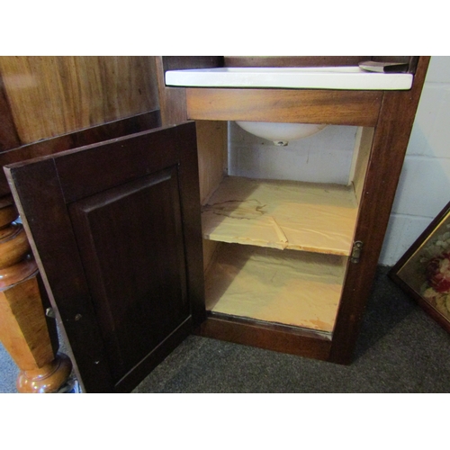 1021 - A late Victorian mahogany campaign wash cupboard with ceramic basin and brass waste