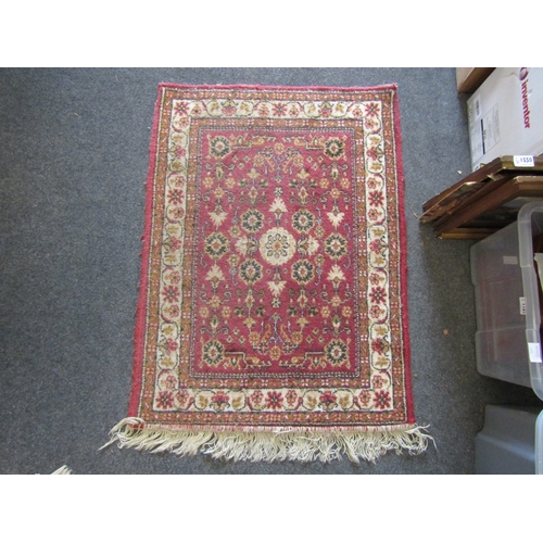 1175 - A small red ground rug with multiple borders, 100cm x 75cm