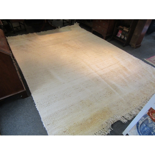 1621 - A large modern beige ground kilim rug with tasselled ends, some discolouration, 370cm x 270cm