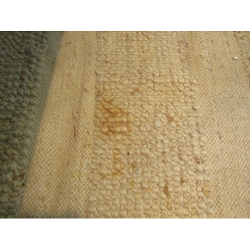 1621 - A large modern beige ground kilim rug with tasselled ends, some discolouration, 370cm x 270cm