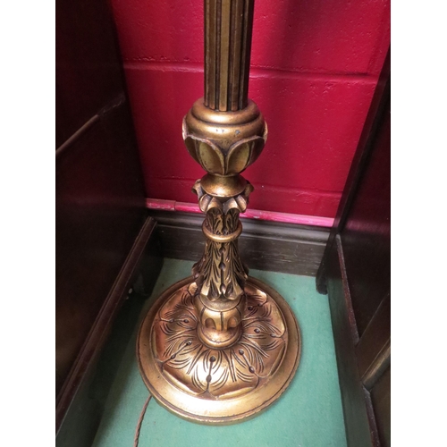 4107 - A carved and reeded gilt standard lamp on a circular base