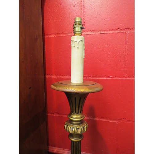 4107 - A carved and reeded gilt standard lamp on a circular base