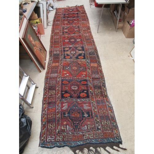 6452 - A mid 20th Century Caucasian Kazak runner rug, hand woven, 450cm x 111cm