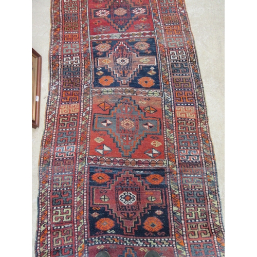 6452 - A mid 20th Century Caucasian Kazak runner rug, hand woven, 450cm x 111cm