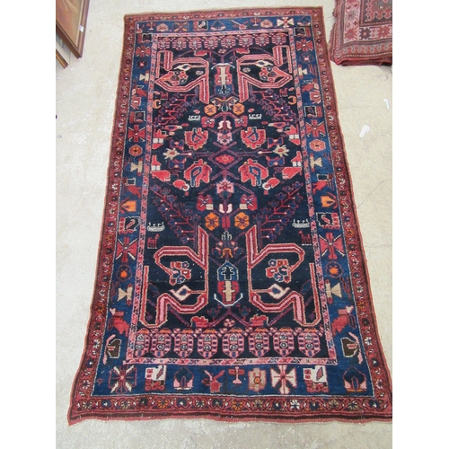 6457 - A mid 20th Century Persian Nahavand hand woven rug, deep blue colour with floral and animal motifs, ... 