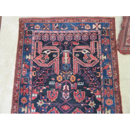 6457 - A mid 20th Century Persian Nahavand hand woven rug, deep blue colour with floral and animal motifs, ... 