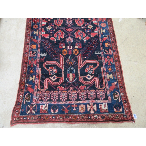 6457 - A mid 20th Century Persian Nahavand hand woven rug, deep blue colour with floral and animal motifs, ... 