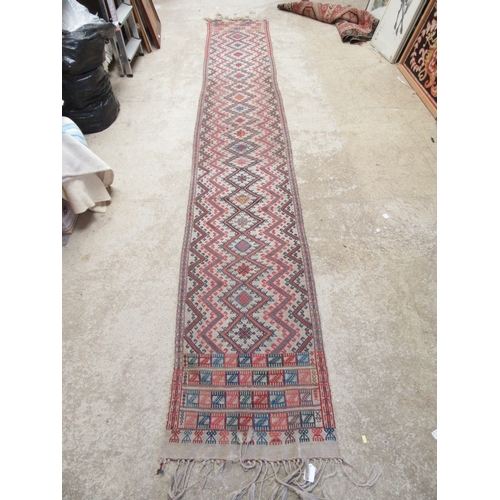 6464 - An early to mid 20th Century slim hand woven runner with lozenge and zig-zag pattern 378cm x 58cm