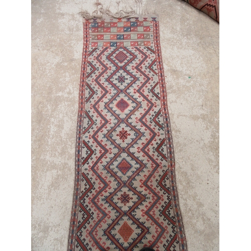 6464 - An early to mid 20th Century slim hand woven runner with lozenge and zig-zag pattern 378cm x 58cm