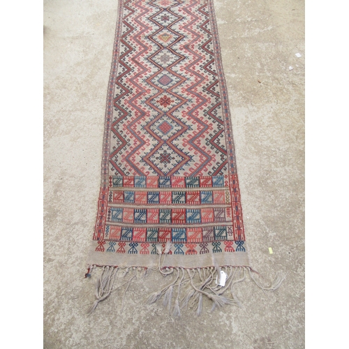 6464 - An early to mid 20th Century slim hand woven runner with lozenge and zig-zag pattern 378cm x 58cm