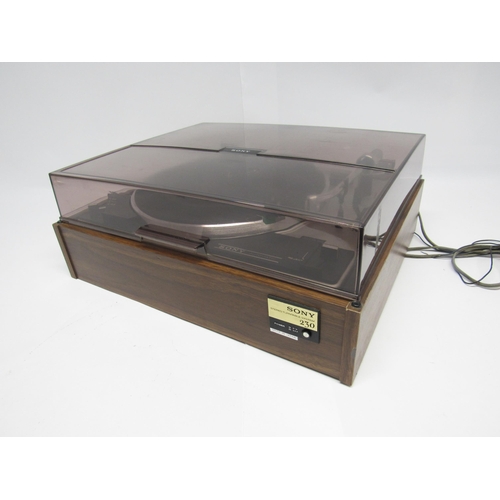 7464 - Hi-fi - A Sony PS 230 turntable, raised on teak effect base with smoked perspex lid