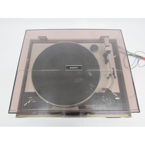 7464 - Hi-fi - A Sony PS 230 turntable, raised on teak effect base with smoked perspex lid