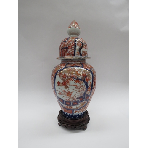 6003 - A Japanese Imari lidded vase/ginger jar with wooden stand, 38cm tall