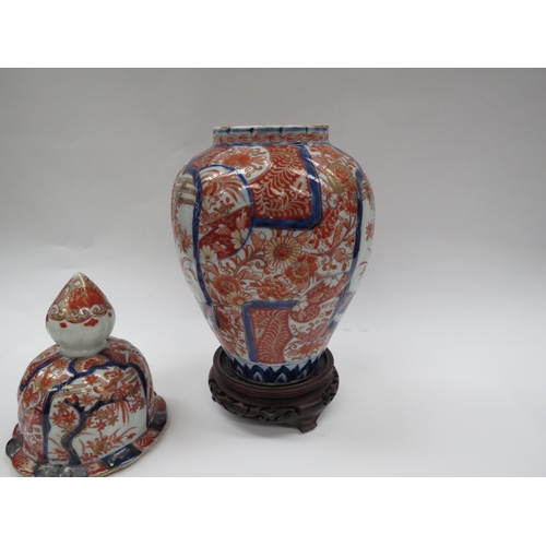 6003 - A Japanese Imari lidded vase/ginger jar with wooden stand, 38cm tall